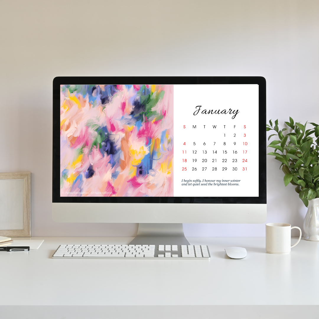 Computer monitor displaying a colorful abstract design with a January calendar on a white desk.